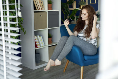 Woman sitting on chair at home