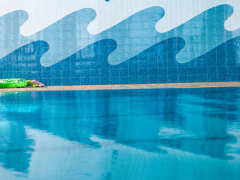 Reflection of man in swimming pool