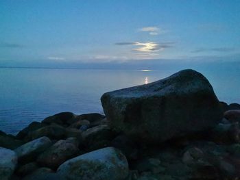 Scenic view of rocks on beach against sky