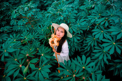 Woman standing by plants