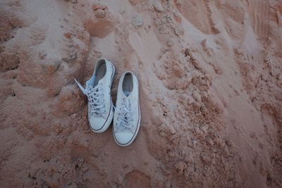 High angle view of shoes on sand at beach