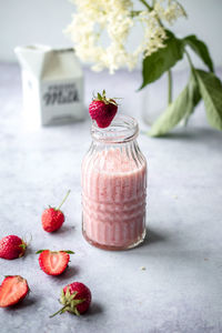 Close-up of strawberries in glass jar on table