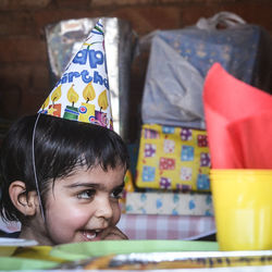 Close-up of boy wearing party hat at home