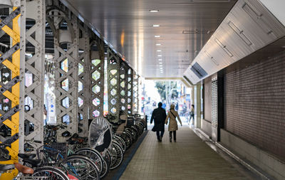 People walking in illuminated building