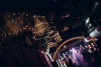 Low angle view of illuminated people at night