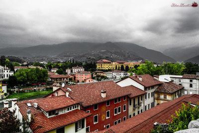 View of townscape against cloudy sky