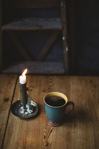 Black coffee and candle on table