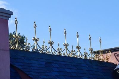 Low angle view of ornate building against blue sky