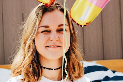 Close-up of young woman with balloons