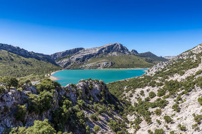 Scenic view of mountains against blue sky