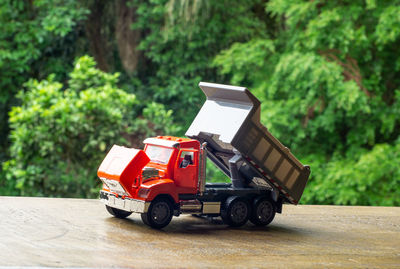 Vintage car on road against trees