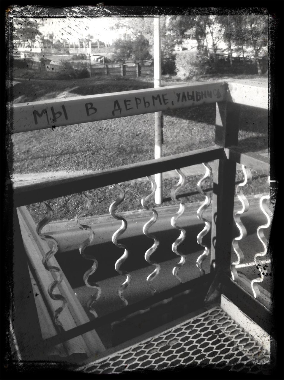 transfer print, auto post production filter, high angle view, day, table, outdoors, no people, text, wood - material, sunlight, bench, communication, built structure, chair, tree, railing, western script, empty, metal