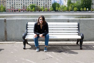 Young woman sitting on bench