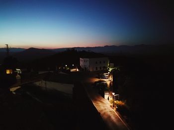 High angle view of illuminated buildings against sky at night