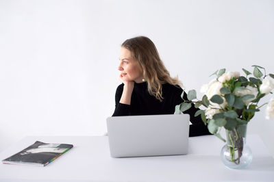 Young woman using laptop on table