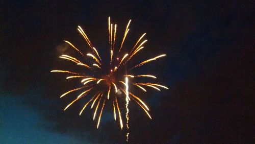 Low angle view of firework display at night