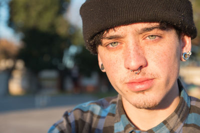 Close-up portrait of young man wearing hat