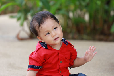 Cute boy sitting outdoors