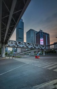 View of city street and buildings against sky