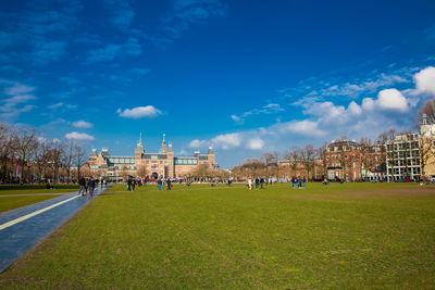 People enjoying an spring day at  the famous museum square next to the national museum in amsterdam