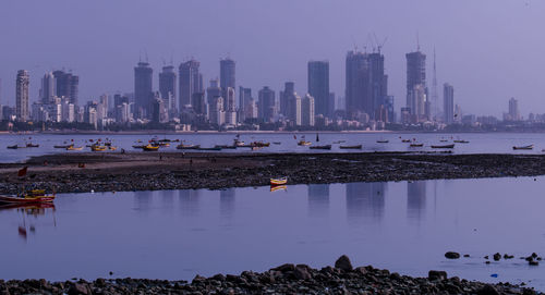 Scenic view of river and buildings against sky
