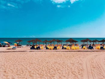 Scenic view of beach against blue sky