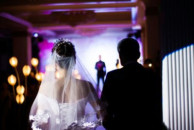 Rear view of bride and father at wedding ceremony