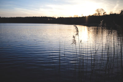 Scenic view of lake against sky during sunset