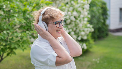 Portrait of woman standing against plants