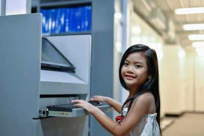 Portrait of smiling girl using computer