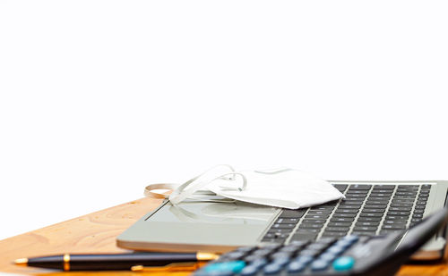 Close-up of laptop on table against white background