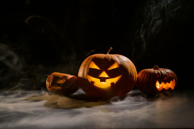 Close-up of illuminated pumpkin against black background