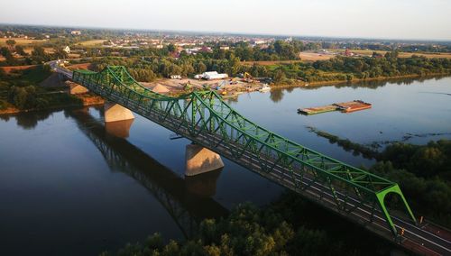 Bridge over river with built structures in distance