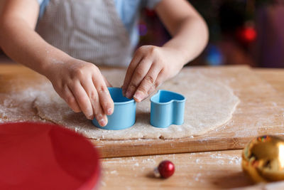 Midsection of boy preparing food on cutting board