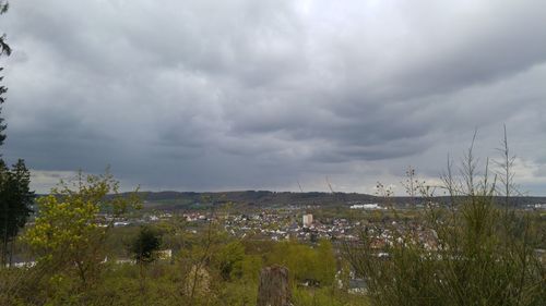 Scenic view of field against cloudy sky