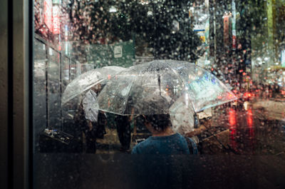 Rear view of woman in rain