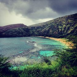 Scenic view of lake and mountains against sky