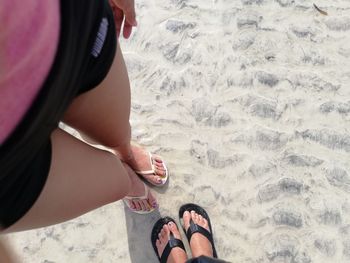 Low section of woman standing on beach