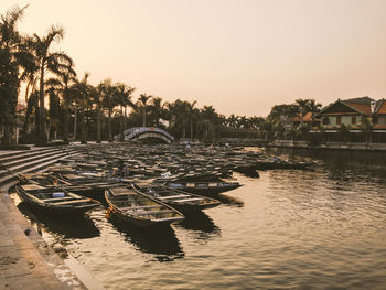 Boats moored in sea against clear sky