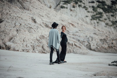 Rear view of couple standing on land