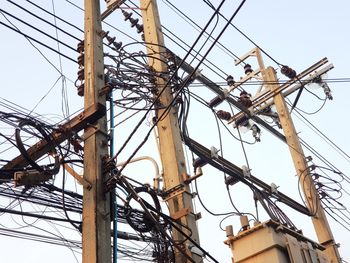 Low angle view of electricity pylon against sky