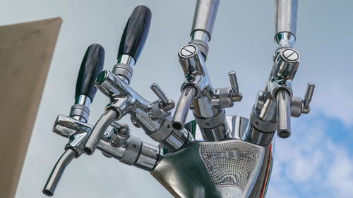 Low angle view of machinery against sky