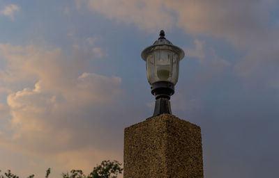 Low angle view of electric lamp against sky