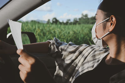 Young woman driver find the way and using map