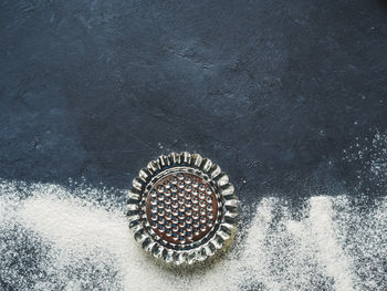 High angle view of metal grate against black background