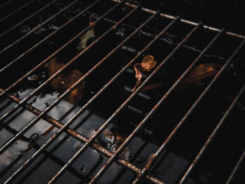 High angle view of metal grate over water