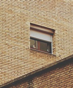 Low angle view of window on wall of building