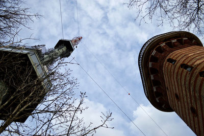 Low angle view of tree and building against sky