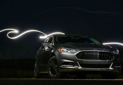 Cars parked on road at night