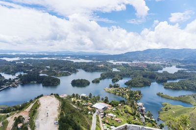 High angle view of river amidst trees against sky